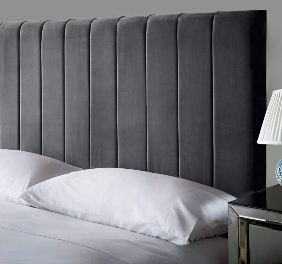 Close-up of grey velvet fluted headboard on divan bed set with mattress from The Panel Outlet Ireland.
